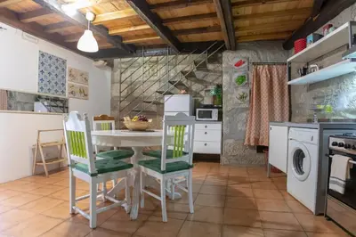 a kitchen with a table and chairs in a room at Red House- Historic center in Porto