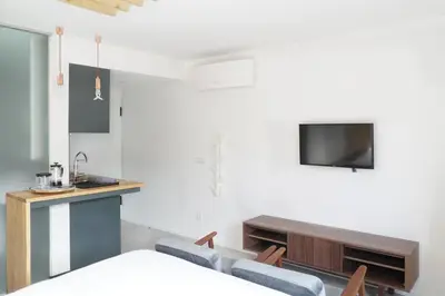 a room with a bed and a tv on a wall at 7 Gaia Roaster Apartments in Vila Nova de Gaia