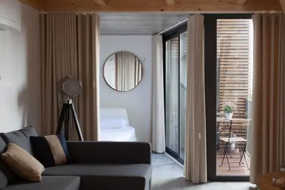 a living room with a couch and a view of a bedroom at 7 Gaia Roaster Apartments in Vila Nova de Gaia