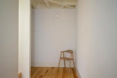 a wooden stool in a room with a white wall at Porto Ildefonso II in Porto