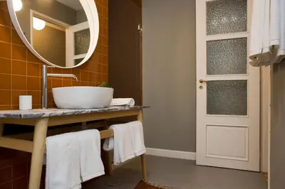 a bathroom with a sink and a mirror at De Porto e Alma in Porto