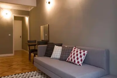 a living room with a couch with pillows on it at De Porto e Alma in Porto