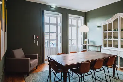 a dining room with a wooden table and chairs at VIVA 4 Suites Batalha Residence & SIZE Flats Batalha in Porto