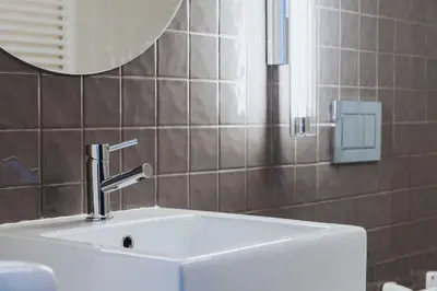 a white sink in a bathroom with a mirror at VIVA 4 Suites Batalha Residence & SIZE Flats Batalha in Porto