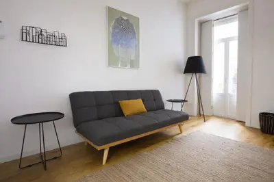 a living room with a couch and a table at Oporto City View - Santa Catarina in Porto