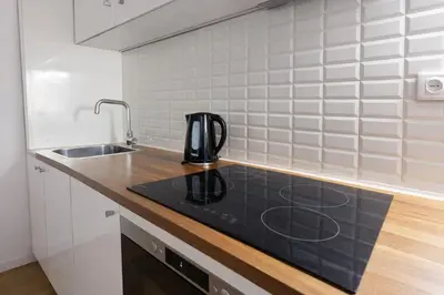 a kitchen with a sink and a coffee pot on a counter at Oporto City View - Santa Catarina in Porto