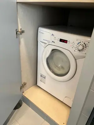 a bathroom with a washing machine in a room at LAZ apartment in Porto