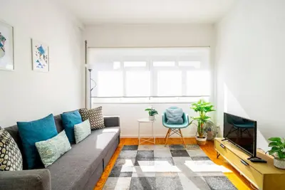 a living room with a couch and a tv at LAZ apartment in Porto