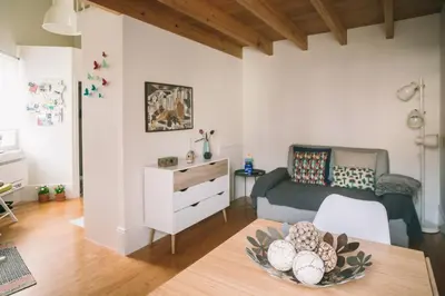 a living room with a bed and a table at Green House / Casa Verde in Porto