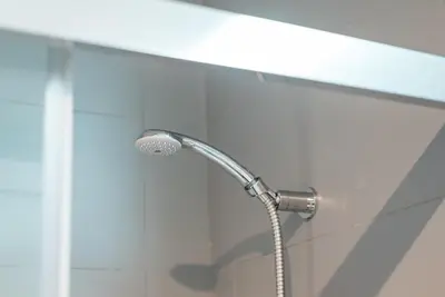 a shower with a shower head in a bathroom at GuestReady - Crayon Walls Apartments in Porto
