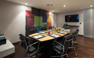 a conference room with a long table and chairs at Pestana Porto - A Brasileira, City Center & Heritage Building in Porto