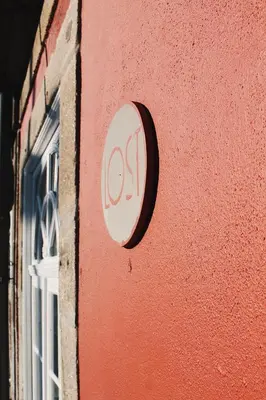 a sign on the side of a building with a window at Lost Apartments in Porto