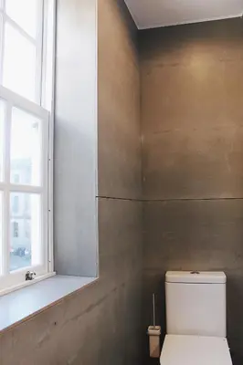a bathroom with a toilet and a window at Lost Apartments in Porto