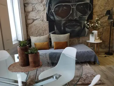 a room with a bed with a statue of a face at the gallery Studios II in Porto