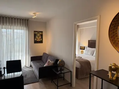 a living room with a couch and a bed and a mirror at ML Apartments Avenue in Porto