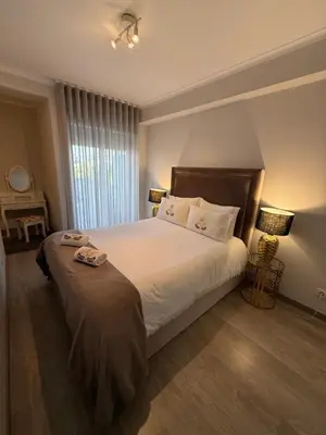 a bedroom with a large bed and a window at ML Apartments Avenue in Porto