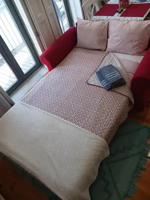 a bed with a white comforter and pillows at Casa da Andorinha, charm apt Porto Bolhão in Porto