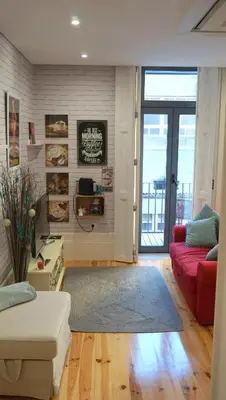 a living room with a couch and a red couch at Casa da Andorinha, charm apt Porto Bolhão in Porto