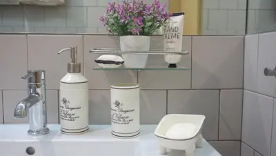 a bathroom with a sink and a toilet and flowers at Casa da Andorinha, charm apt Porto Bolhão in Porto