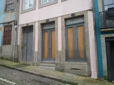 a building with orange doors on a street at Flower's Downtown Porto in Porto