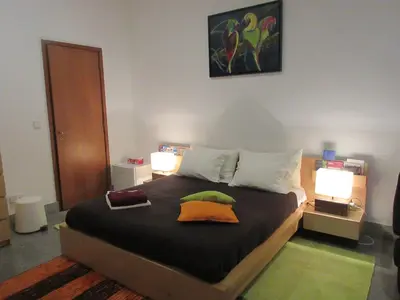 a bedroom with a large bed with two pillows on it at Flower's Downtown Porto in Porto