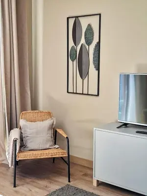 a living room with a blue chair and a book shelf at Flats 323 apartments in Porto