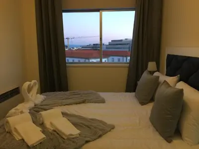 a bedroom with a large bed with a large window at Invicta house Boavista in Porto