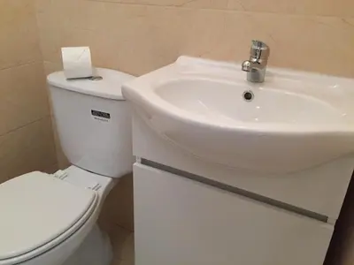 a bathroom with a white toilet and a sink at Invicta house Boavista in Porto