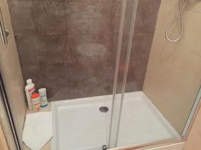 a shower with a glass door in a bathroom at Invicta house Boavista in Porto