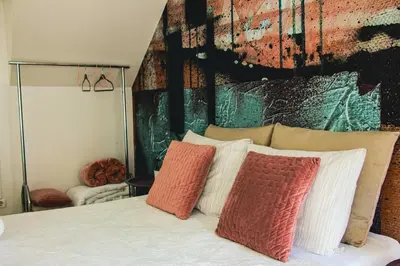 a bedroom with a bed with colorful pillows on it at Hannah's Studios in Porto
