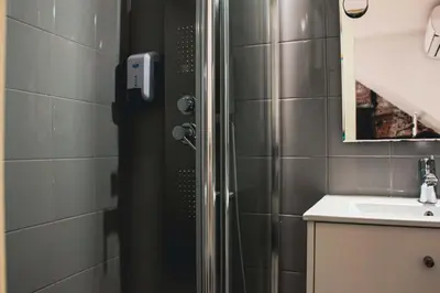 a bathroom with a shower and a sink at Hannah's Studios in Porto