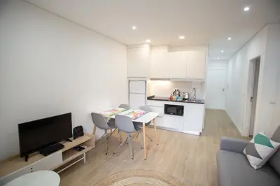 a kitchen and living room with a table and chairs at Camões 691 Design Apartments by Porto City Hosts in Porto