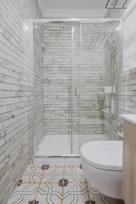 a white bathroom with a shower and a toilet at OHH -S João apartments- Riverside in Porto