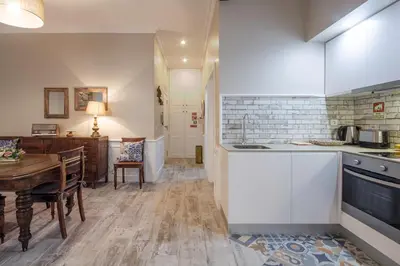 a kitchen with a table and a dining room at OHH -S João apartments- Riverside in Porto
