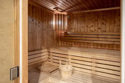 a wooden sauna with a bucket in it at InterContinental Porto - Palacio das Cardosas by IHG in Porto