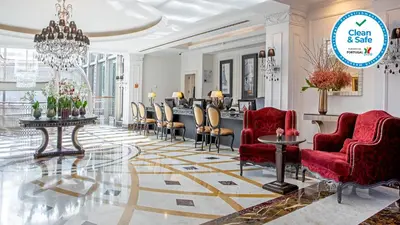 a lobby with red chairs and a barber shop at InterContinental Porto - Palacio das Cardosas by IHG in Porto