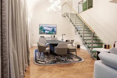 a dining room with a table and chairs and a staircase at InterContinental Porto - Palacio das Cardosas by IHG in Porto