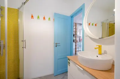 a bathroom with a sink and a blue door at BestVillas Casa do Rio in Vila Nova de Gaia