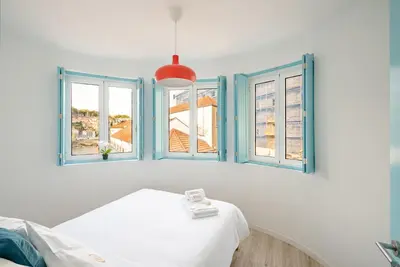 a white room with blue windows and a bed at BestVillas Casa do Rio in Vila Nova de Gaia