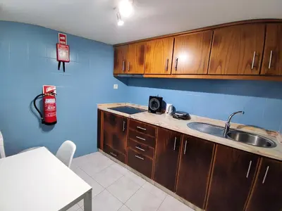 a kitchen with wooden cabinets and a sink and a fire extinguisher at AlfandegaPorto Apartments in Porto
