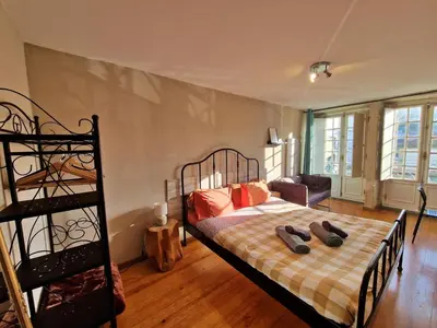 a bedroom with a bed with shoes on it at AlfandegaPorto Apartments in Porto