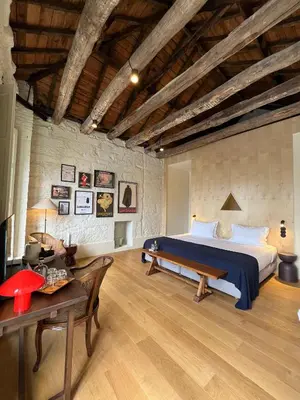 a bedroom with a large bed and a table at The House of Sandeman in Vila Nova de Gaia