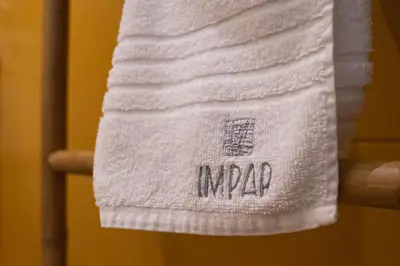 a towel that says mrape hanging on a rack at Impar Triplex House in Porto