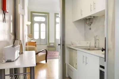 a white kitchen with a sink and a counter at HeartMade Loft & Heartmade Studio in Porto