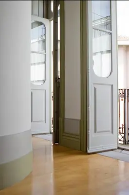 an empty room with two doors and a wooden floor at HeartMade Loft & Heartmade Studio in Porto