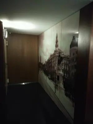a room with a painting of a city on the wall at PATH Dukes Apartment in Porto