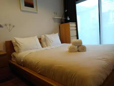 a teddy bear sitting on top of a bed at PATH Dukes Apartment in Porto