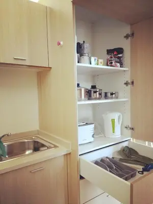 a kitchen with a sink and a cupboard at PATH Biblioteca Apartment in Porto