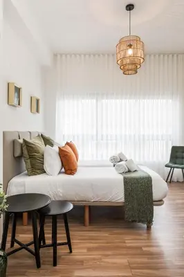 a living room with a white couch and a window at Porto Essence in Porto