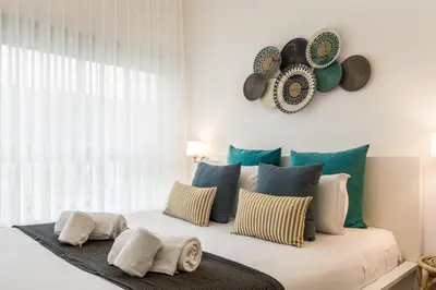 a bedroom with a bed with pillows and a window at Porto Essence in Porto